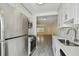 Modern galley kitchen with white cabinets and stainless steel appliances at 208 Danube Ave # 101, Tampa, FL 33606
