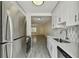 Galley kitchen with stainless steel appliances and stylish gray tiled floor at 208 Danube Ave # 101, Tampa, FL 33606
