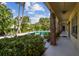 Tranquil pool view with lush tropical landscaping and relaxing lounge chairs at 208 Danube Ave # 101, Tampa, FL 33606