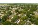 Aerial view featuring a well-maintained residential neighborhood with mature trees, diverse housing, and nearby amenities at 2222 Euclid N Cir, Clearwater, FL 33764