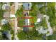 Bird's eye view of a home with a spacious yard, nestled in a neighborhood with mature trees and a community pool at 2222 Euclid N Cir, Clearwater, FL 33764