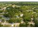 Aerial view of homes surrounded by mature trees and lush landscaping, featuring a community pool at 2222 Euclid N Cir, Clearwater, FL 33764