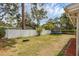 Backyard with a trampoline, partially bordered by a white privacy fence at 2222 Euclid N Cir, Clearwater, FL 33764