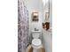 Small bathroom features a toilet and patterned shower curtain for privacy at 2222 Euclid N Cir, Clearwater, FL 33764