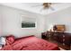 Bedroom features a dresser, and a window with privacy blinds, filled with natural light at 2222 Euclid N Cir, Clearwater, FL 33764