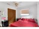 Bedroom with a large closet, nightstand, and dresser, offering ample storage space at 2222 Euclid N Cir, Clearwater, FL 33764