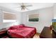 Cozy bedroom with a comfortable bed, wooden nightstand, and a view from the window at 2222 Euclid N Cir, Clearwater, FL 33764