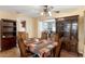 Traditional dining room featuring wood floors, a ceiling fan, and a large china cabinet at 2222 Euclid N Cir, Clearwater, FL 33764