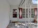 Covered front porch with a white storm door, diamond-shaped shutters, and decorative wrought iron features at 2222 Euclid N Cir, Clearwater, FL 33764