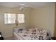 A bright bedroom with a ceiling fan, window blinds, and a comfortable quilt on the bed at 2463 Brazilia Dr # 43, Clearwater, FL 33763