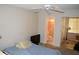 A bedroom with carpet, window, and an adjacent bathroom at 2463 Brazilia Dr # 43, Clearwater, FL 33763
