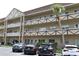 A low-rise multi-Gathering condominium building with a beautiful palm tree, and parking at 2463 Brazilia Dr # 43, Clearwater, FL 33763