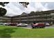 Angle view of a multi-Gathering condominium building with a landscaped grass lawn and car parking at 2463 Brazilia Dr # 43, Clearwater, FL 33763