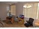 A living room featuring window blinds, ceiling fan, tile floors, and a desk at 2463 Brazilia Dr # 43, Clearwater, FL 33763