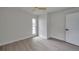 Bright bedroom featuring light wood-look flooring, a ceiling fan, and a modern door at 2575 Granada E Cir, St Petersburg, FL 33712