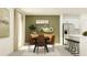 Dining area with modern table, chairs, and decorative accents adjacent to the kitchen at 2718 Bryce Ravine Ave, Plant City, FL 33563