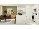Bright kitchen and dining area featuring white cabinetry, stainless steel appliances, and an island with bar seating at 2718 Bryce Ravine Ave, Plant City, FL 33563
