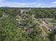 Aerial view of a home with mature landscaping, near the city at 2724 W Henry Ave, Tampa, FL 33614