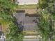 Aerial view of a home with a fenced yard and mature trees at 2724 W Henry Ave, Tampa, FL 33614