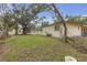 Spacious backyard features lush green grass and mature trees at 2724 W Henry Ave, Tampa, FL 33614