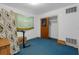 Modest bedroom with closet, small window and blue carpeting, ready for customization at 2724 W Henry Ave, Tampa, FL 33614
