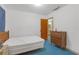 Modest bedroom with bed, dresser and open door to the bathroom, ready for customization at 2724 W Henry Ave, Tampa, FL 33614