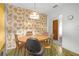 Dining room area features a table with four chairs and bright wallpaper at 2724 W Henry Ave, Tampa, FL 33614