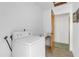 Bright laundry area features a washing machine and an adjacent doorway at 2724 W Henry Ave, Tampa, FL 33614