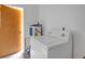 Functional laundry area showing a white washing machine and hot water tank at 2724 W Henry Ave, Tampa, FL 33614