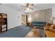 Bright living room with wallpaper accent wall, classic furnishings, and carpeting at 2724 W Henry Ave, Tampa, FL 33614
