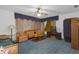 Cozy living room with plush seating, carpeting, and a ceiling fan at 2724 W Henry Ave, Tampa, FL 33614