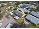 An aerial view of the villa surrounded by carports, mature trees, and a beautiful community pool at 2749 Countryside Blvd # 4, Clearwater, FL 33761