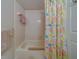 Bright bathroom with a bathtub and a colorful floral shower curtain at 2749 Countryside Blvd # 4, Clearwater, FL 33761