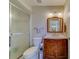 Well-lit bathroom with a glass enclosed shower and dark wood vanity at 2749 Countryside Blvd # 4, Clearwater, FL 33761