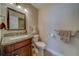 Bathroom featuring a granite vanity, a toilet and neutral walls at 2749 Countryside Blvd # 4, Clearwater, FL 33761