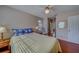 Bedroom with wood floors, a ceiling fan and access to the ensuite bathroom at 2749 Countryside Blvd # 4, Clearwater, FL 33761