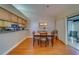 Dining room with wood floors, dining set, and sliding glass doors at 2749 Countryside Blvd # 4, Clearwater, FL 33761