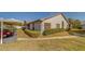 View of the condo building with well-maintained landscaping at 2749 Countryside Blvd # 4, Clearwater, FL 33761