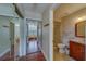 Hallway with mirrored closet leading to a bathroom and bedroom at 2749 Countryside Blvd # 4, Clearwater, FL 33761