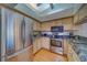 Stainless steel refrigerator and appliances in well lit kitchen at 2749 Countryside Blvd # 4, Clearwater, FL 33761