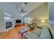 Cozy living room featuring a fireplace and ceiling fan at 2749 Countryside Blvd # 4, Clearwater, FL 33761