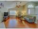 Open living room with vaulted ceiling, ceiling fan, and natural light at 2749 Countryside Blvd # 4, Clearwater, FL 33761