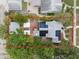 Aerial view showcases a property with solar panels, a detached garage, and a beautifully landscaped yard at 2859 Dartmouth N Ave, St Petersburg, FL 33713