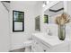 Bright bathroom featuring a modern vanity, toilet, shower with stylish tile and decorative plant at 2859 Dartmouth N Ave, St Petersburg, FL 33713