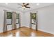 Sun-filled bedroom featuring hardwood floors, neutral walls, and three windows with window treatments at 2859 Dartmouth N Ave, St Petersburg, FL 33713