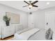 Bright bedroom featuring hardwood floors, white walls, a ceiling fan, and ample storage spaces at 2859 Dartmouth N Ave, St Petersburg, FL 33713