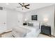 Well-lit bedroom with hardwood floors, a ceiling fan, and white walls is decorated with neutral tones at 2859 Dartmouth N Ave, St Petersburg, FL 33713