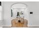 Bright dining room features an arched doorway, hardwood floors and a modern table with four chairs at 2859 Dartmouth N Ave, St Petersburg, FL 33713