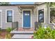 The exterior of the house showcases a covered porch and a blue front door at 2859 Dartmouth N Ave, St Petersburg, FL 33713