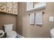 Charming half-bath includes a toilet and decorative cabinet with stylish accent towels at 2859 Dartmouth N Ave, St Petersburg, FL 33713